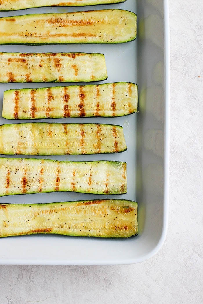 Turn on the grill and throw on some zucchini! Making grilled zucchini is easy and if you do it right you'll end up with grilled zucchini with a little crunch rather than a soggy mess. Grab the zucchini from your garden or the grocery store and get grilling! grilled zucchini in a baking dish