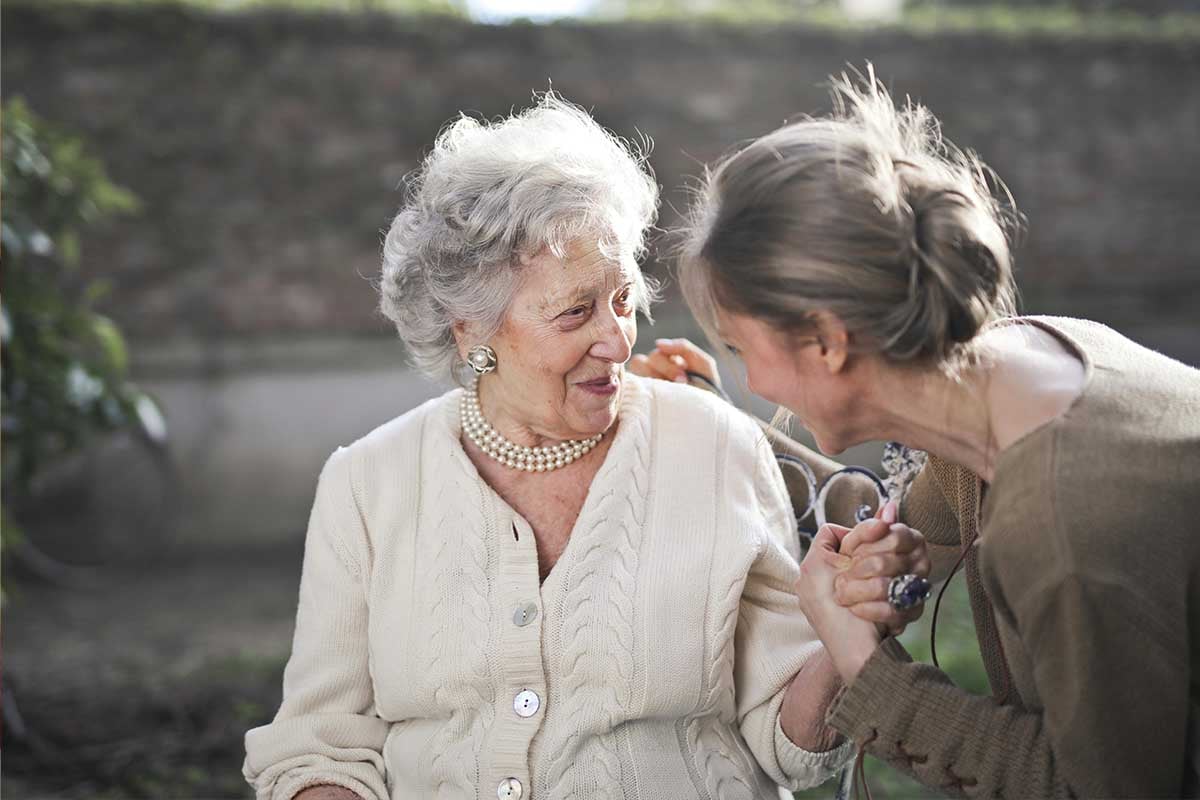Young woman and older woman talking
