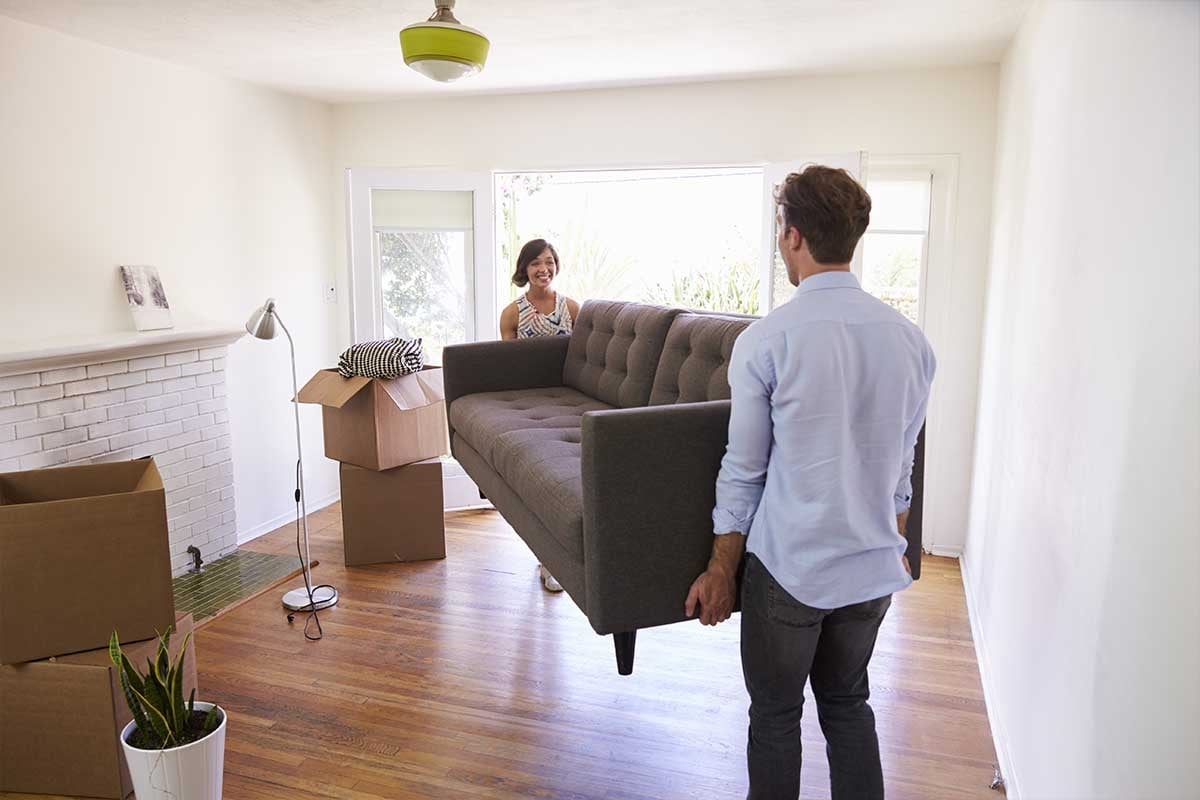 Man and woman moving a couch