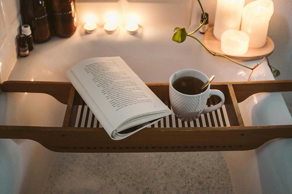 Book and tea in a bathtub